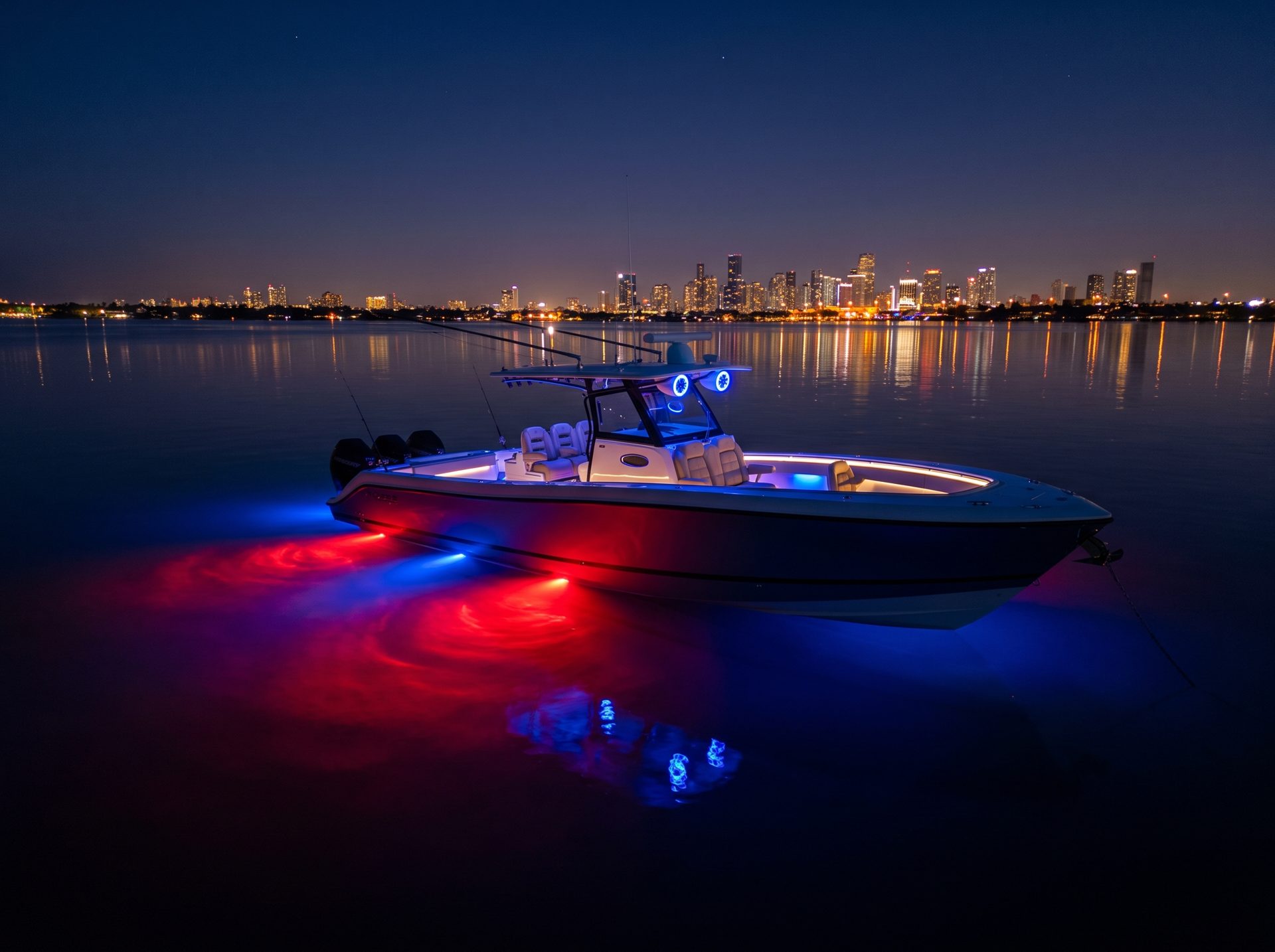 Boat at night with red and blue RGB underwater lights